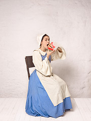 Image showing Medieval Woman in Historical Costume Wearing Corset Dress and Bonnet.