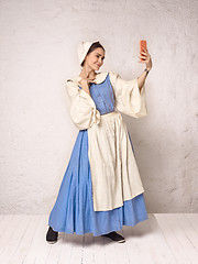 Image showing Medieval Woman in Historical Costume Wearing Corset Dress and Bonnet.