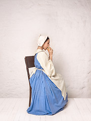 Image showing Medieval Woman in Historical Costume Wearing Corset Dress and Bonnet.