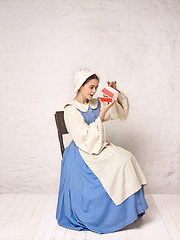 Image showing Medieval Woman in Historical Costume Wearing Corset Dress and Bonnet.