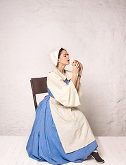 Image showing Medieval Woman in Historical Costume Wearing Corset Dress and Bonnet.