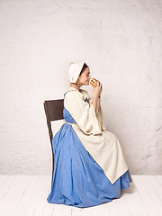 Image showing Medieval Woman in Historical Costume Wearing Corset Dress and Bonnet.