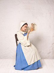 Image showing Medieval Woman in Historical Costume Wearing Corset Dress and Bonnet.