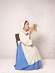 Image showing Medieval Woman in Historical Costume Wearing Corset Dress and Bonnet.