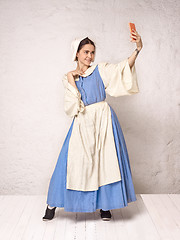 Image showing Medieval Woman in Historical Costume Wearing Corset Dress and Bonnet.