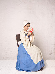 Image showing Medieval Woman in Historical Costume Wearing Corset Dress and Bonnet.