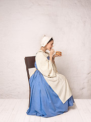 Image showing Medieval Woman in Historical Costume Wearing Corset Dress and Bonnet.