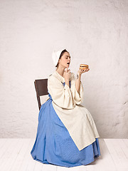 Image showing Medieval Woman in Historical Costume Wearing Corset Dress and Bonnet.