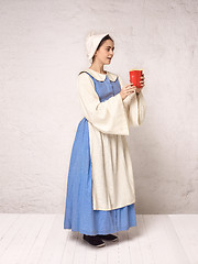 Image showing Medieval Woman in Historical Costume Wearing Corset Dress and Bonnet.