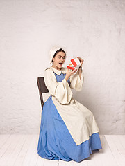 Image showing Medieval Woman in Historical Costume Wearing Corset Dress and Bonnet.