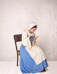 Image showing Medieval Woman in Historical Costume Wearing Corset Dress and Bonnet.