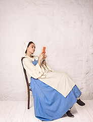 Image showing Medieval Woman in Historical Costume Wearing Corset Dress and Bonnet.