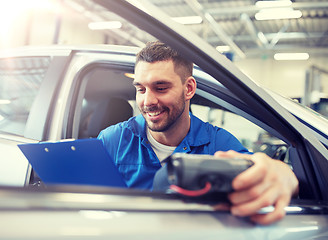 Image showing mechanic man with diagnostic scanner at car shop