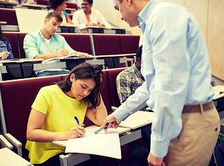 Image showing group of students and teacher with notebook