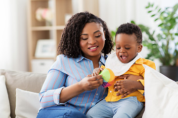 Image showing mother and baby playing with ball at home