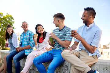 Image showing friends drinking coffee and juice talking in city