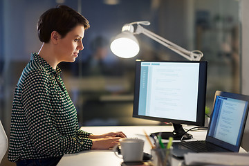 Image showing businesswoman working on laptop at night office