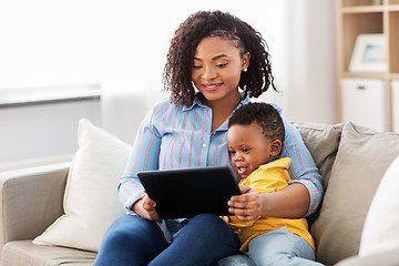 Image showing mother using tablet pc with baby son at home