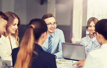 Image showing architects with laptop and blueprint at office