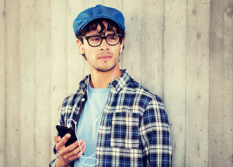 Image showing man with earphones and smartphone listening music