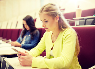 Image showing student girls with smartphones on lecture