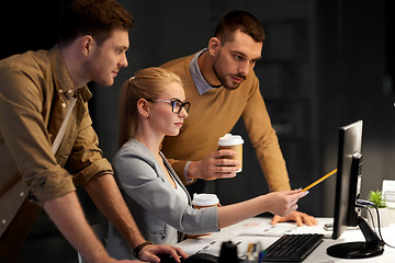 Image showing business team with computer working late at office