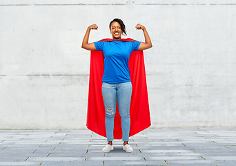 Image showing happy african american woman in superhero red cape