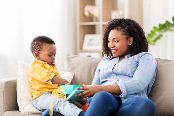 Image showing happy mother and baby with open gift box at home