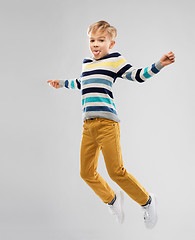 Image showing happy little boy jumping and having fun