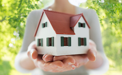 Image showing close up of hands holding house or home model