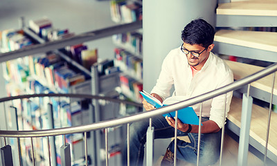 Image showing hindu student boy or man reading book at library