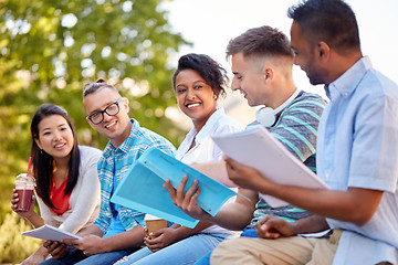 Image showing group of happy students with notebooks and drinks