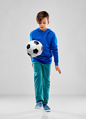 Image showing smiling boy in blue hoodie playing soccer ball
