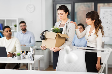 Image showing female office worker with box of personal stuff