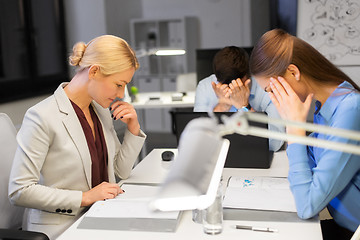 Image showing business team with laptop working late at office