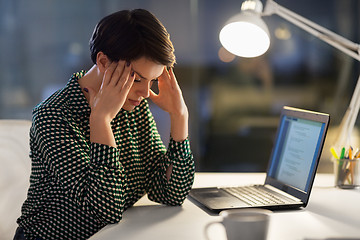 Image showing stressed businesswoman at night office