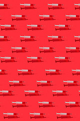 Image showing Medicinal pattern of flying syringes with red blood or vaccine.