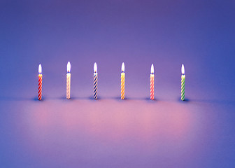 Image showing Birthday composition from burning candles for sweet cakes.