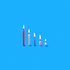 Image showing Holiday burning multicolored candles of different height.