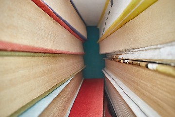 Image showing Piled up books macro view between them