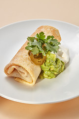 Image showing Homemade pancake roll with spicy guacamole and white sauces.