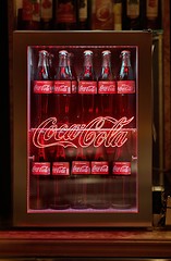 Image showing Bottles of Coca Cola in a fridge with logo