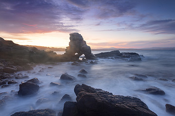 Image showing Sun setting behind the cave arch rock