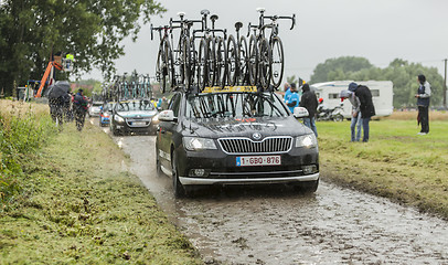 Image showing Row of Technical Cars on a Cobblestone Road - Tour de France 201