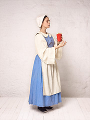 Image showing Medieval Woman in Historical Costume Wearing Corset Dress and Bonnet.