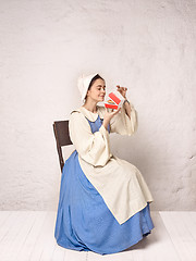 Image showing Medieval Woman in Historical Costume Wearing Corset Dress and Bonnet.