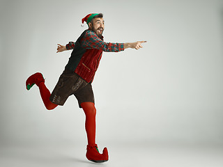 Image showing friendly man dressed like a funny gnome posing on an isolated gray background