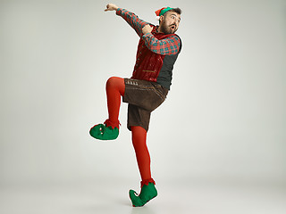 Image showing friendly man dressed like a funny gnome posing on an isolated gray background