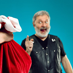 Image showing An elderly man with white hair and beard and Christmas gift bag.