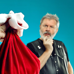 Image showing An elderly man with white hair and beard and Christmas gift bag.